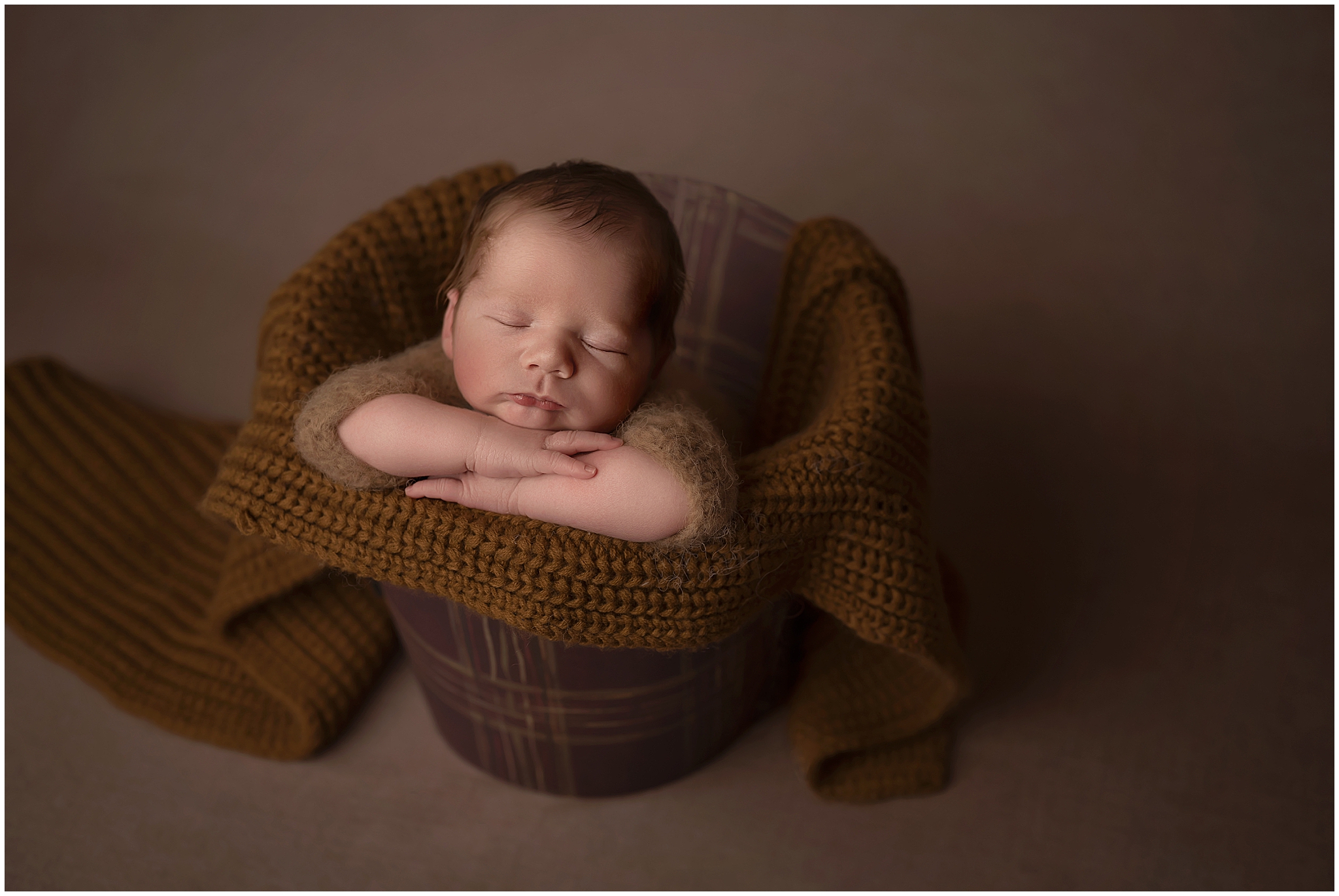 baby boy posed in bucket in london ontario photography studio