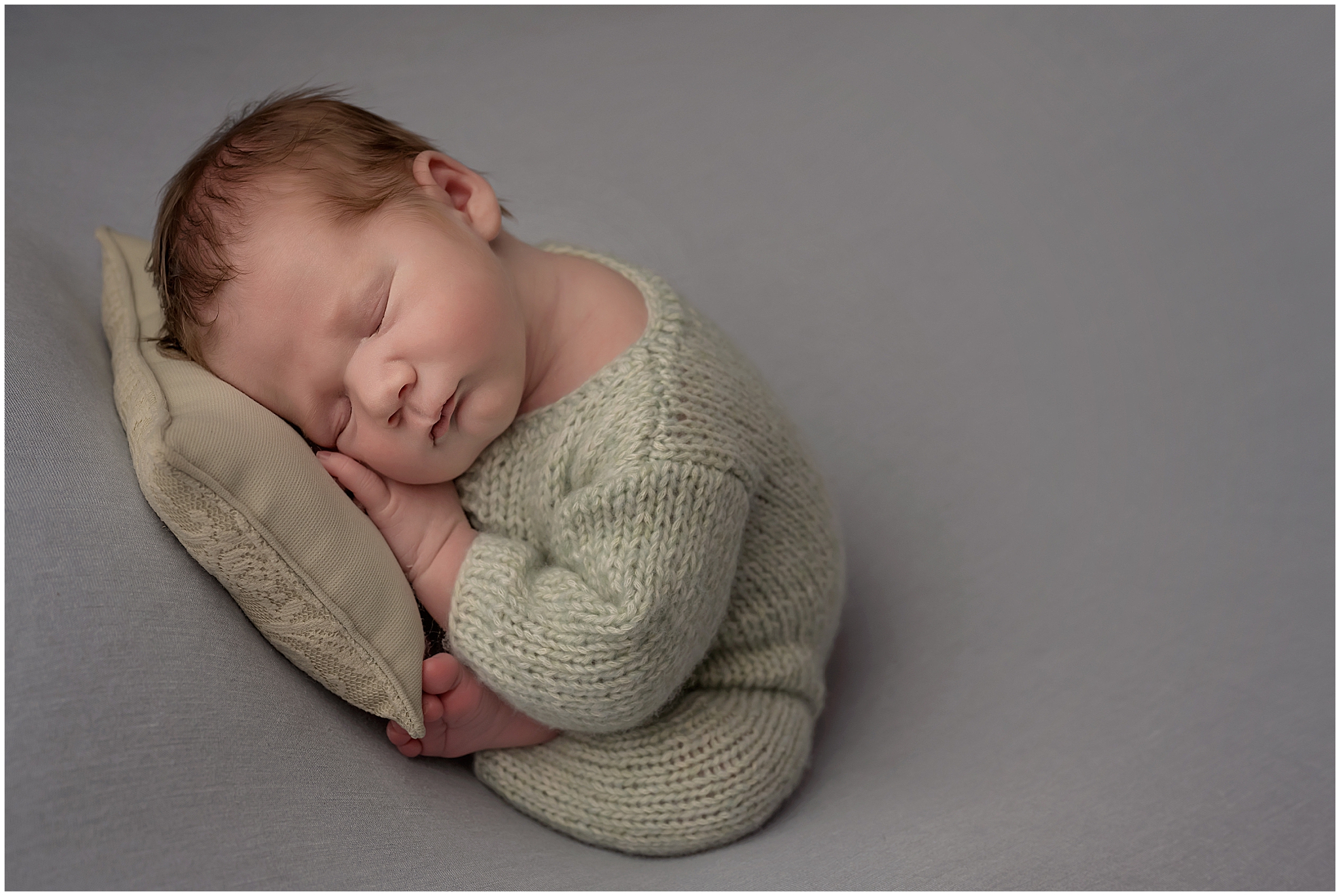 baby in london resting on pillow in taco pose