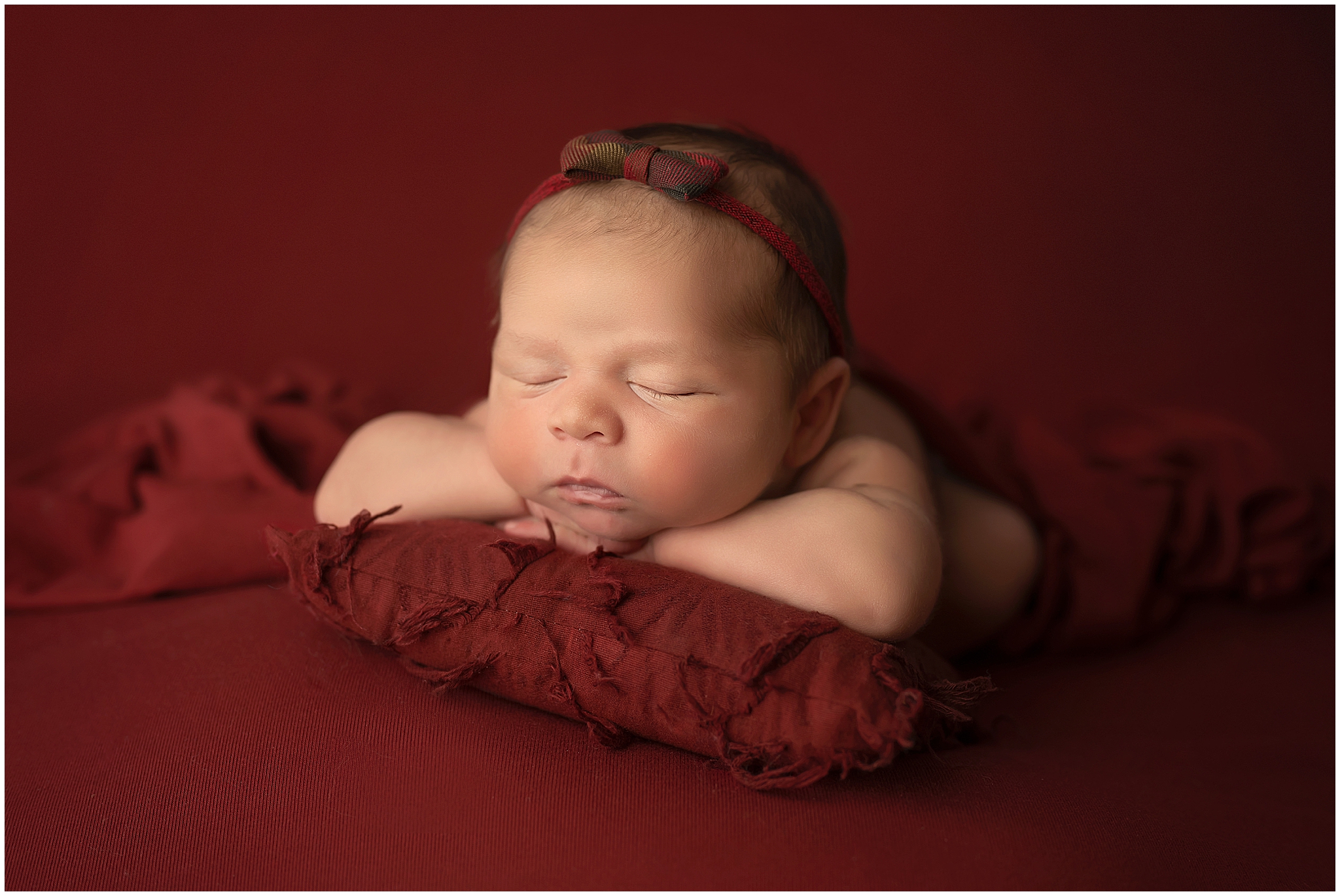 newborn baby resting on pillow at newborn session in london ontario
