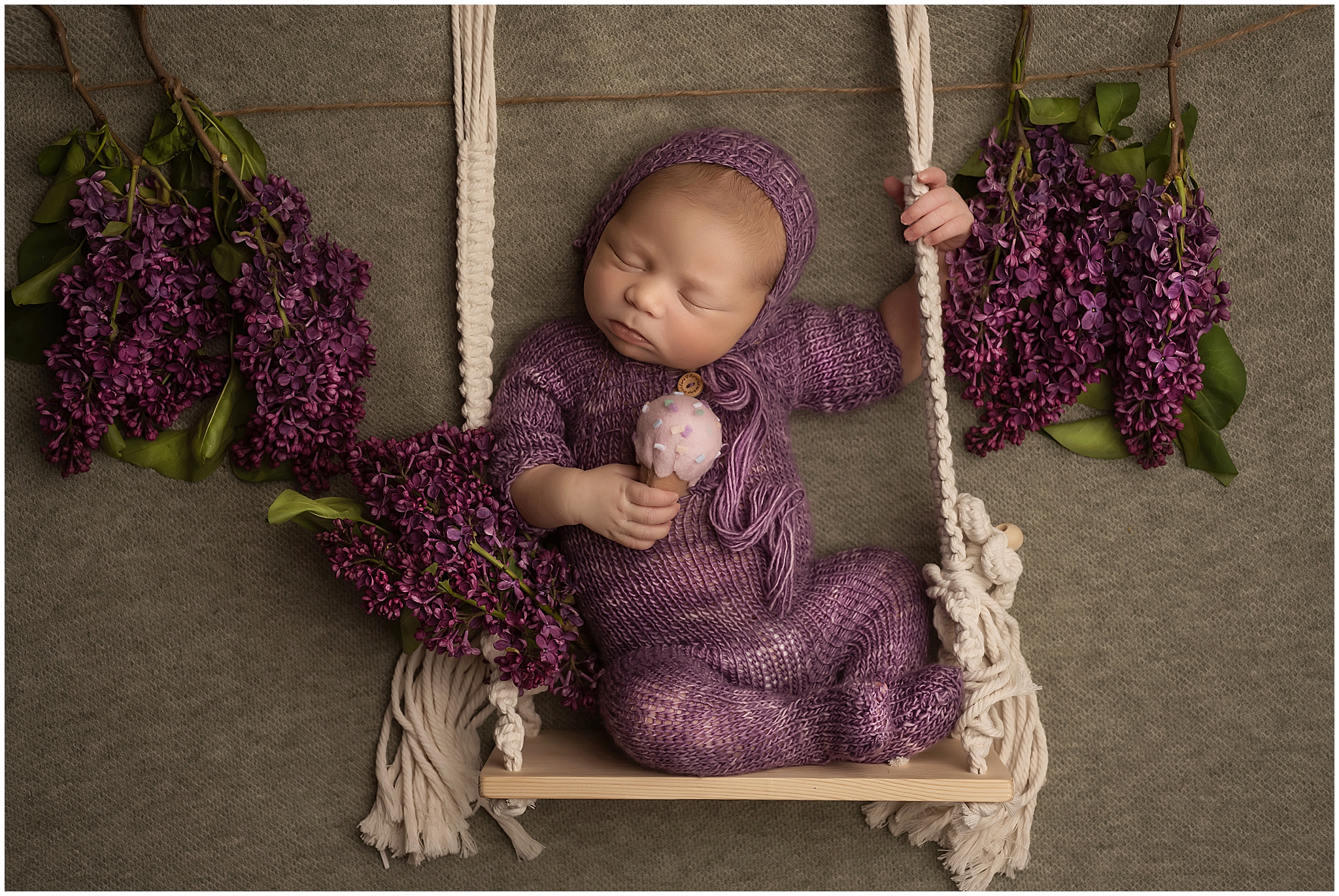 newborn baby on swing holding ice cream cones at london ontario photography studio