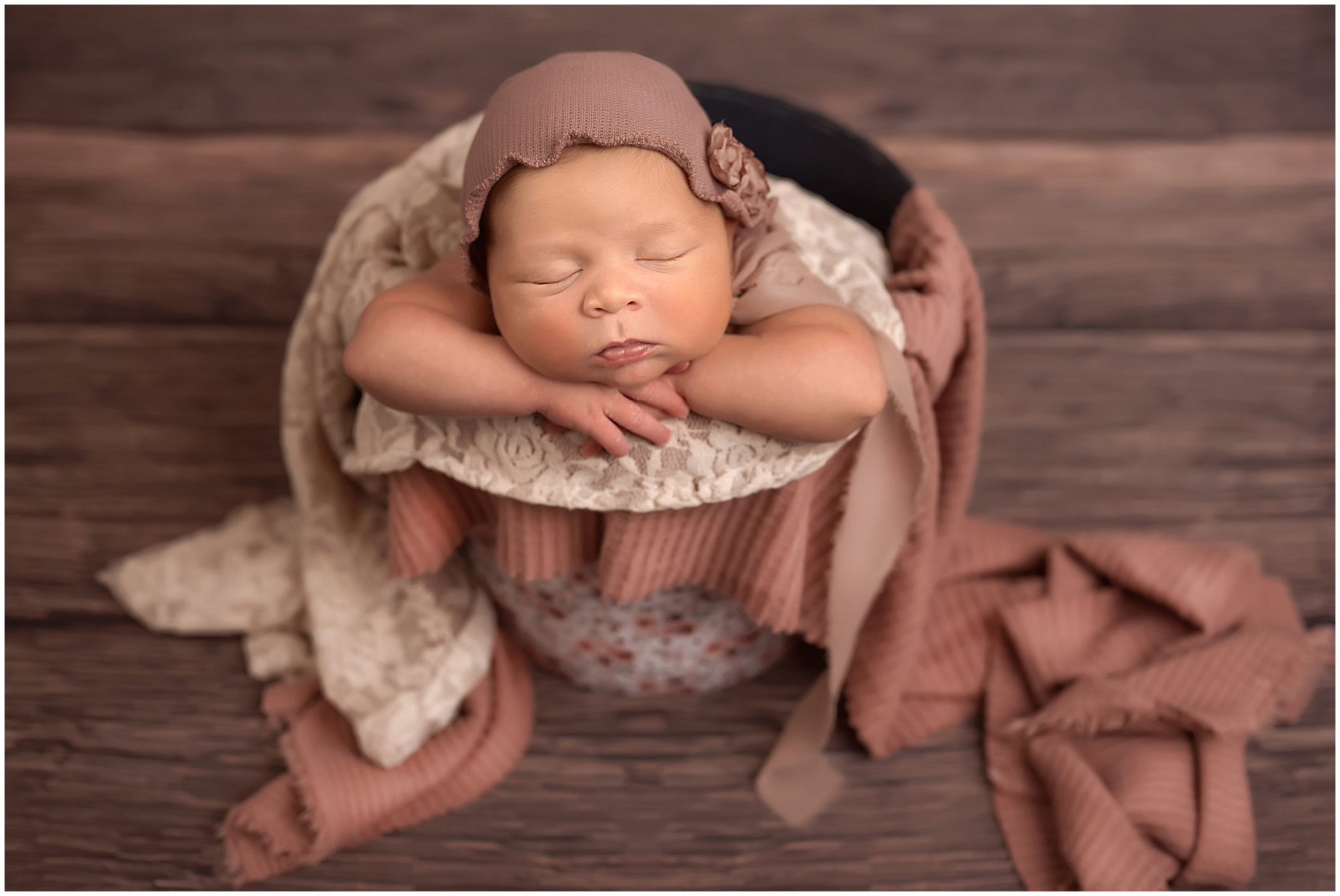 newborn baby girl in bucket at london ontario photography studio