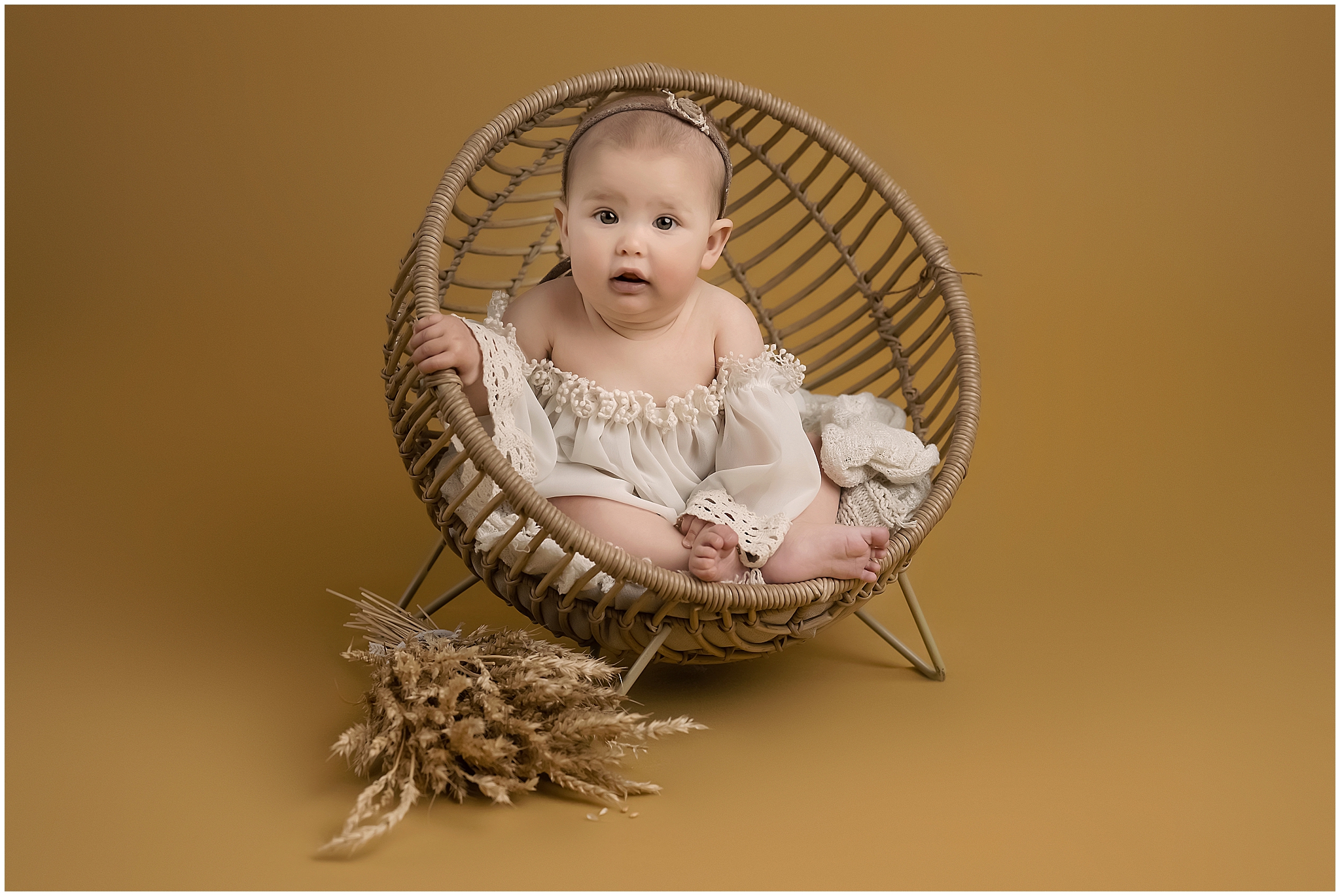 baby sitting in boho chair during milestone session in london ontario