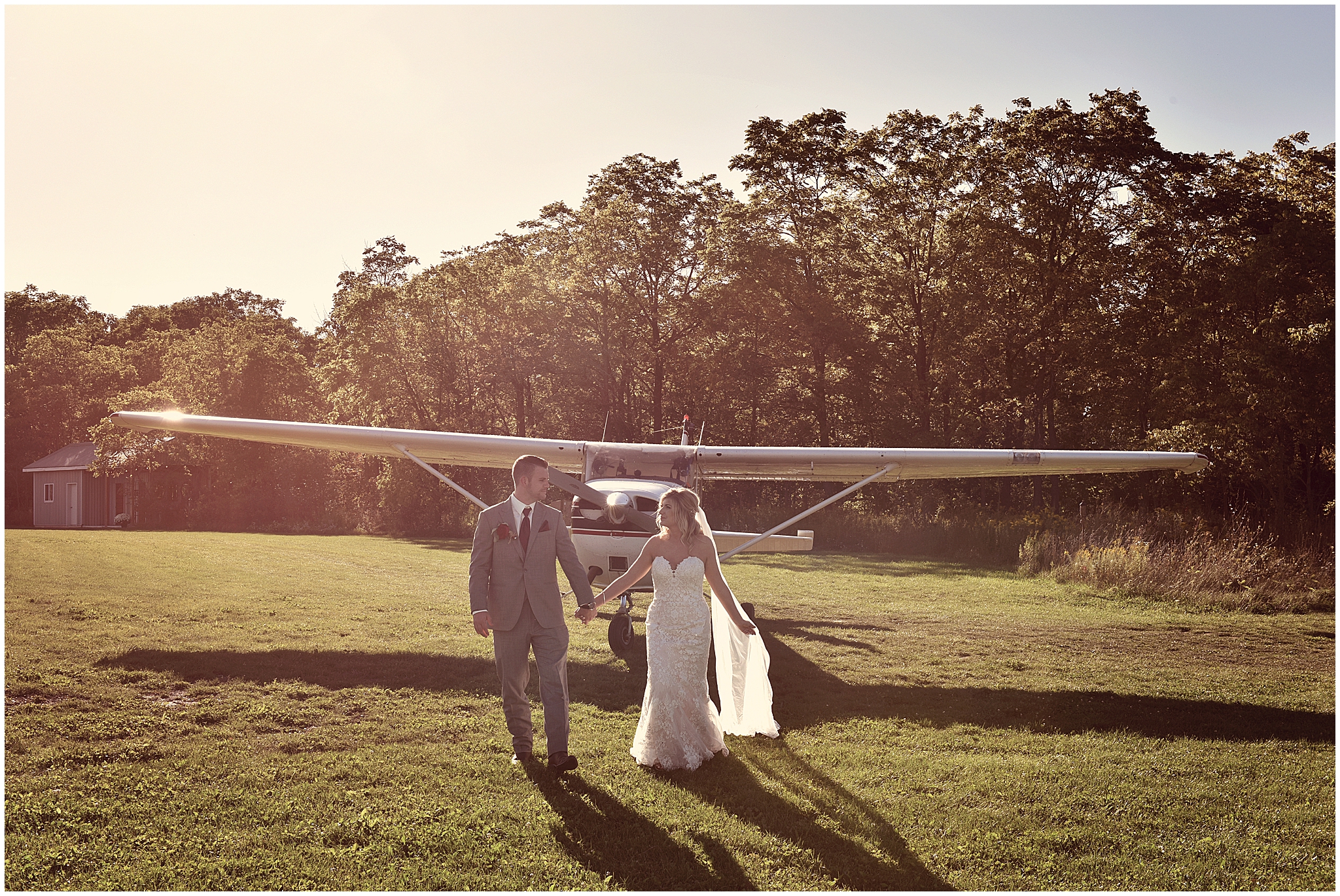 bride and groom walking away from airplane