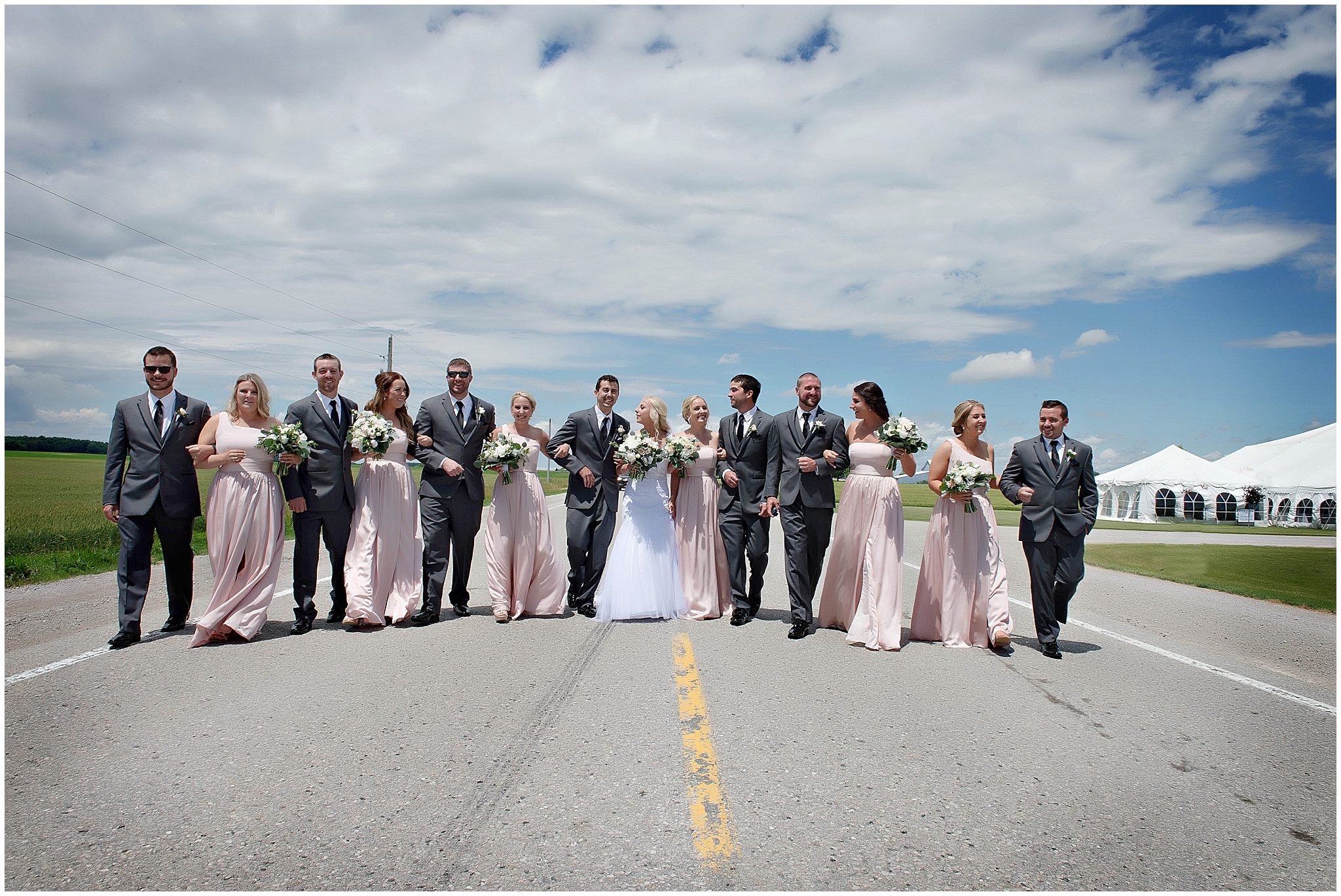 bride and groom with friends on road in exeter ontario