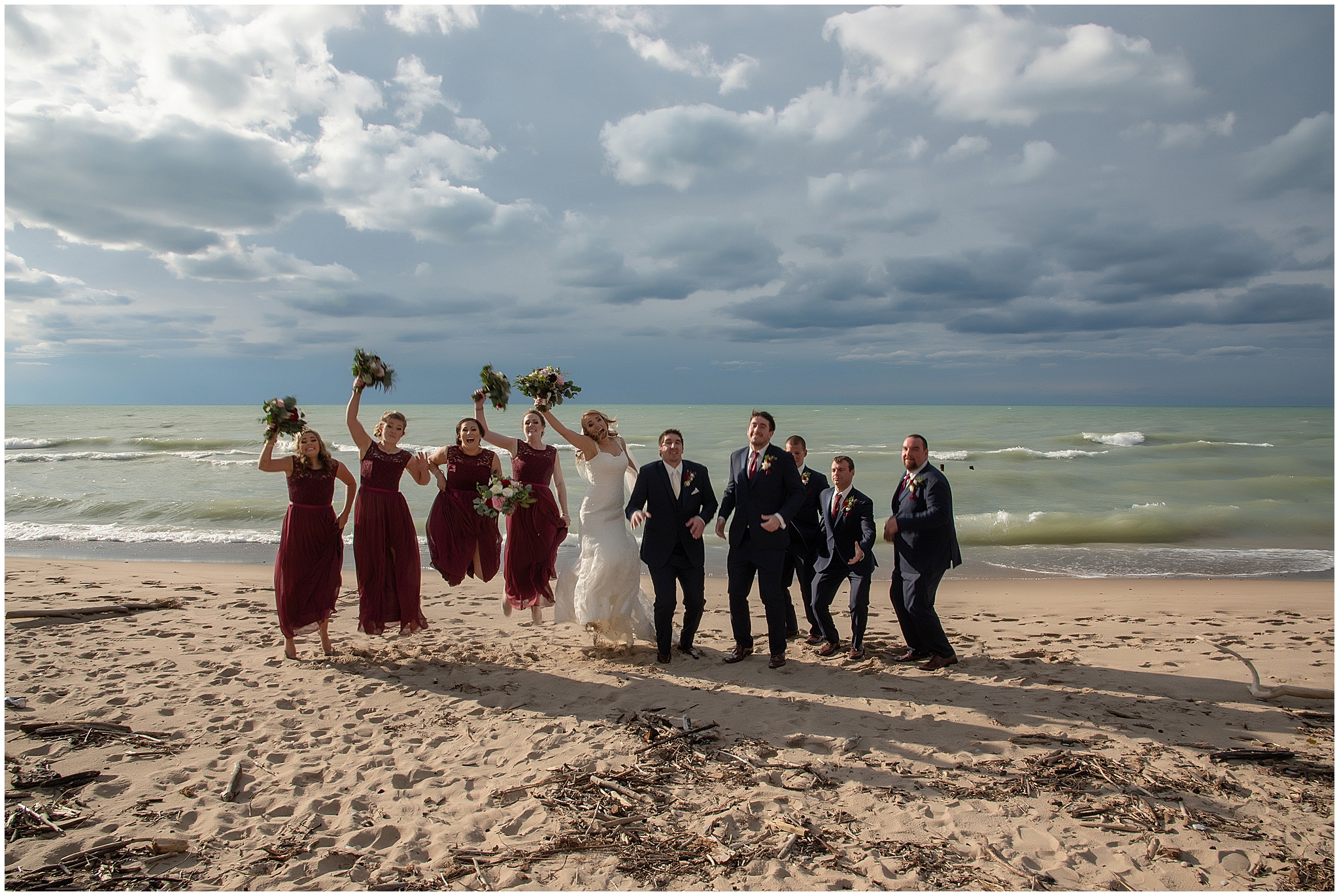bride and groom with friends on beach in grand bend ontario