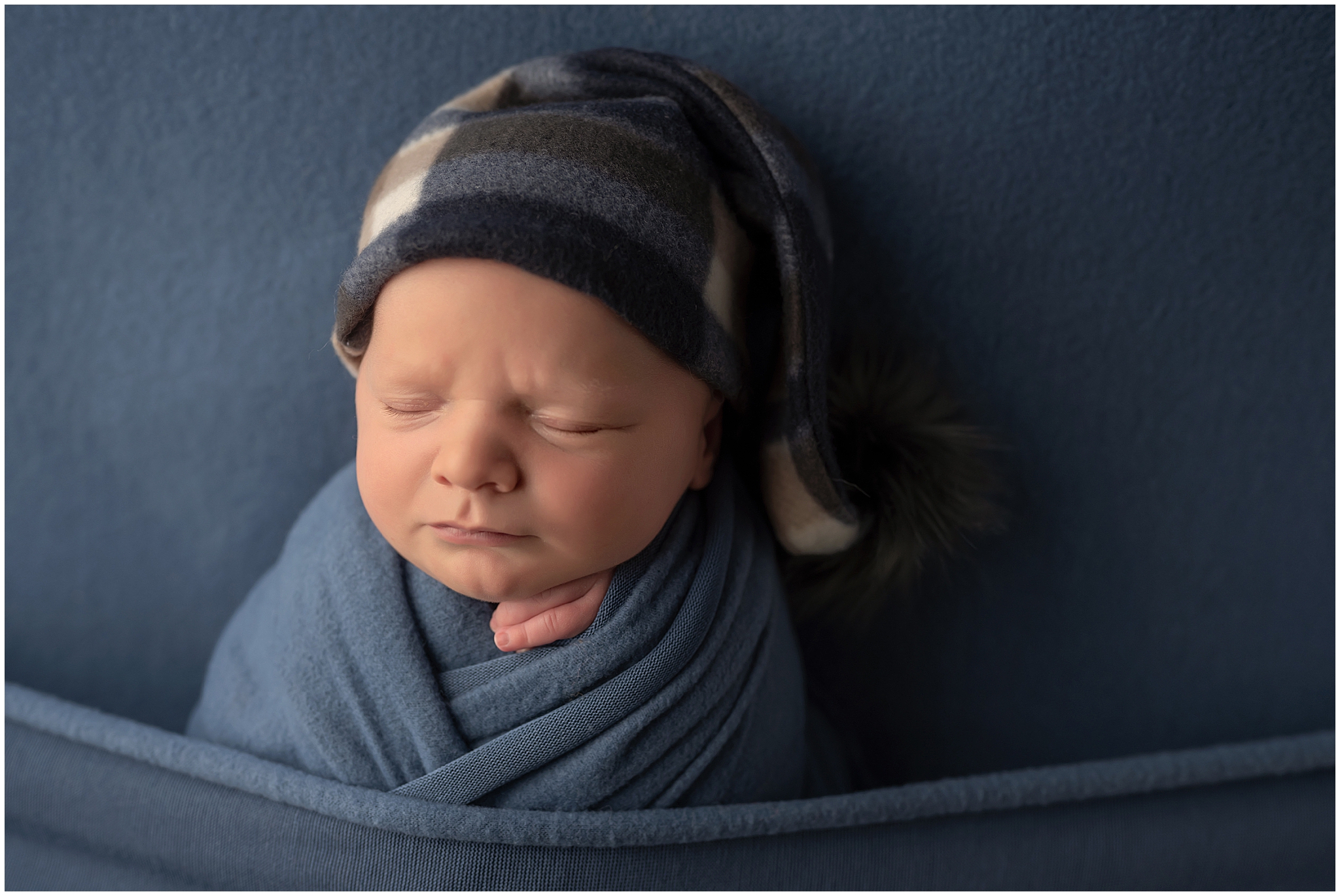 newborn baby dressed in blue
