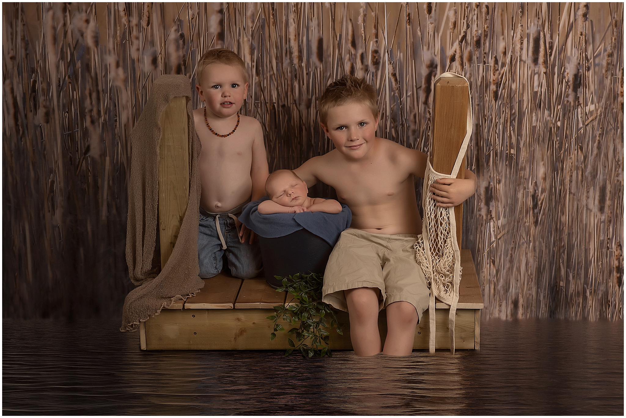 three brothers on fishing dock during newborn session in london ontario