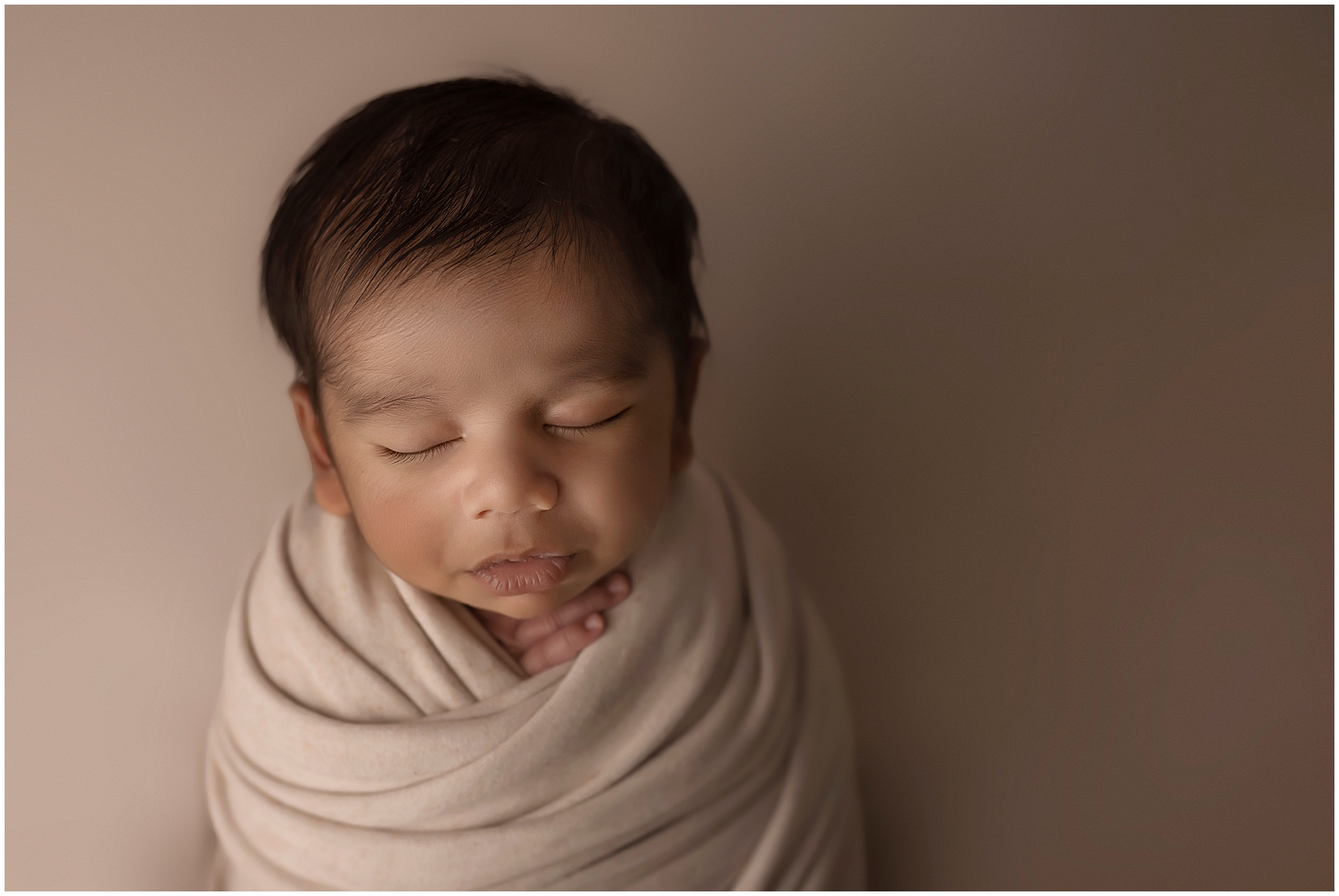 newborn baby in potato sac pose in photography studio in london ontario