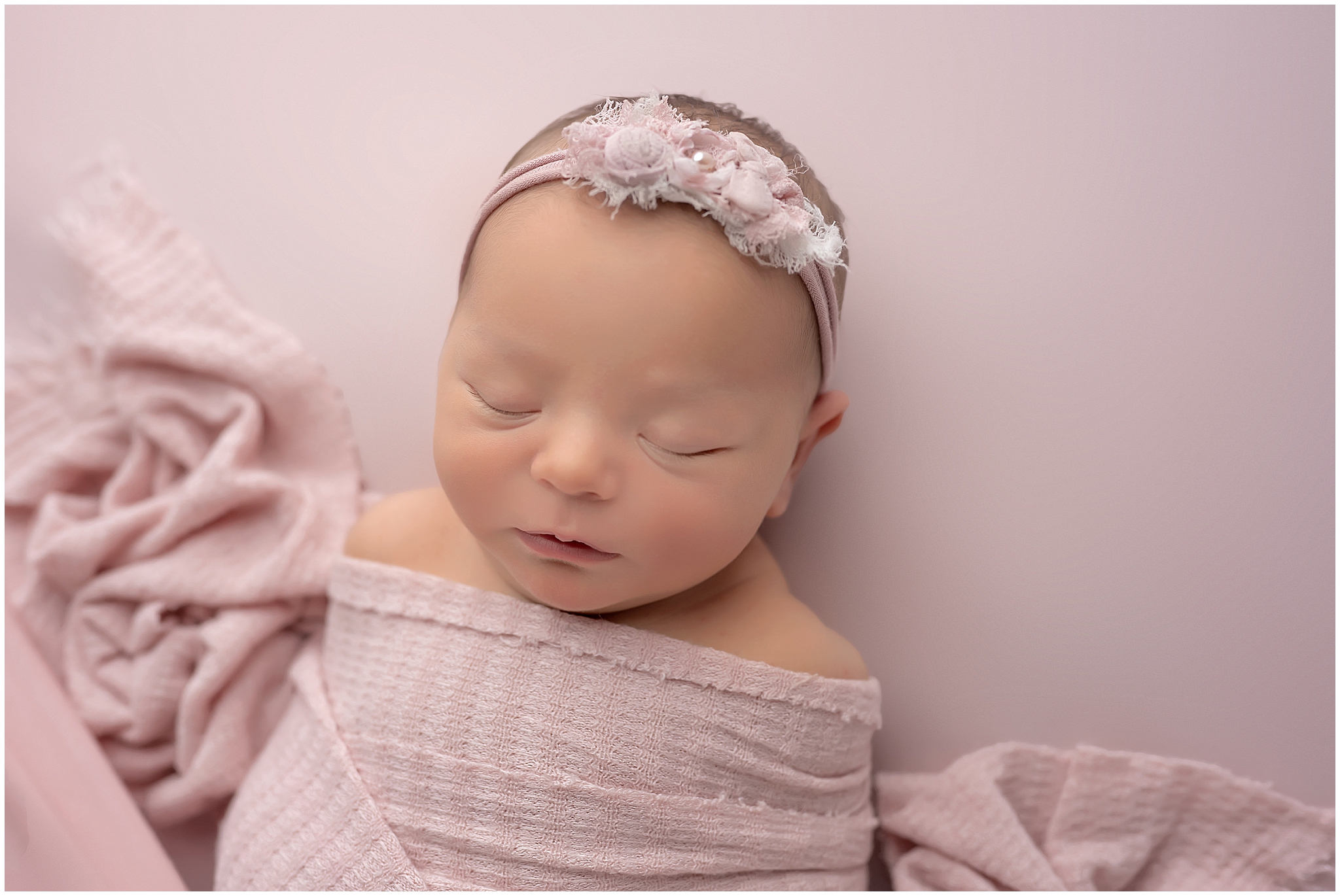 baby sleeping on pink fabric during newborn photography session in london ontario