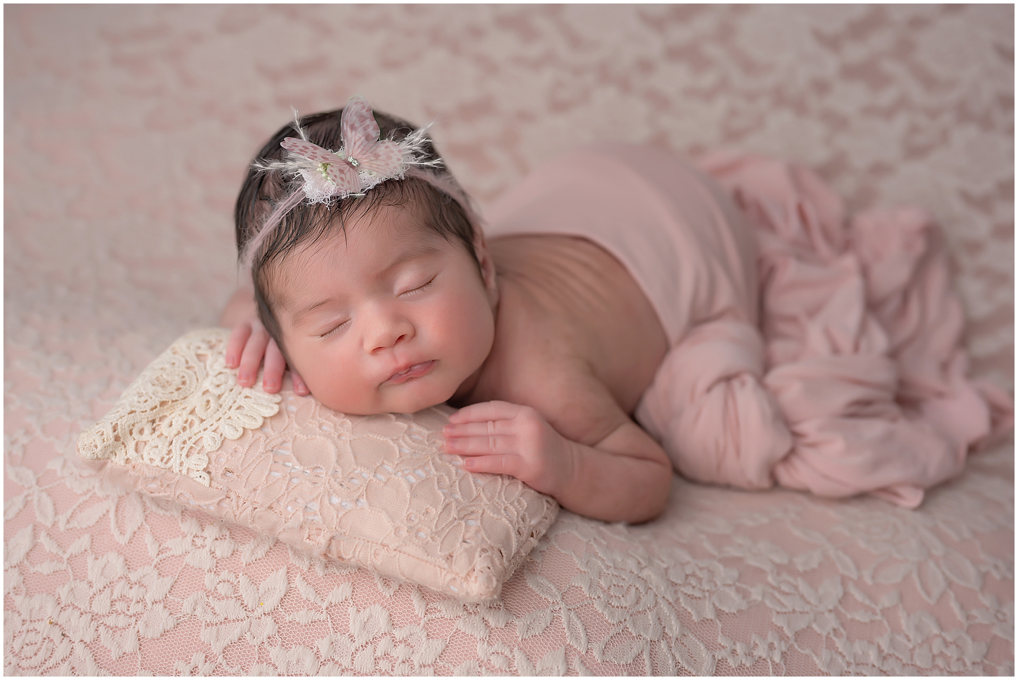 baby girl sleeping on pink during newborn photography session in london ontario