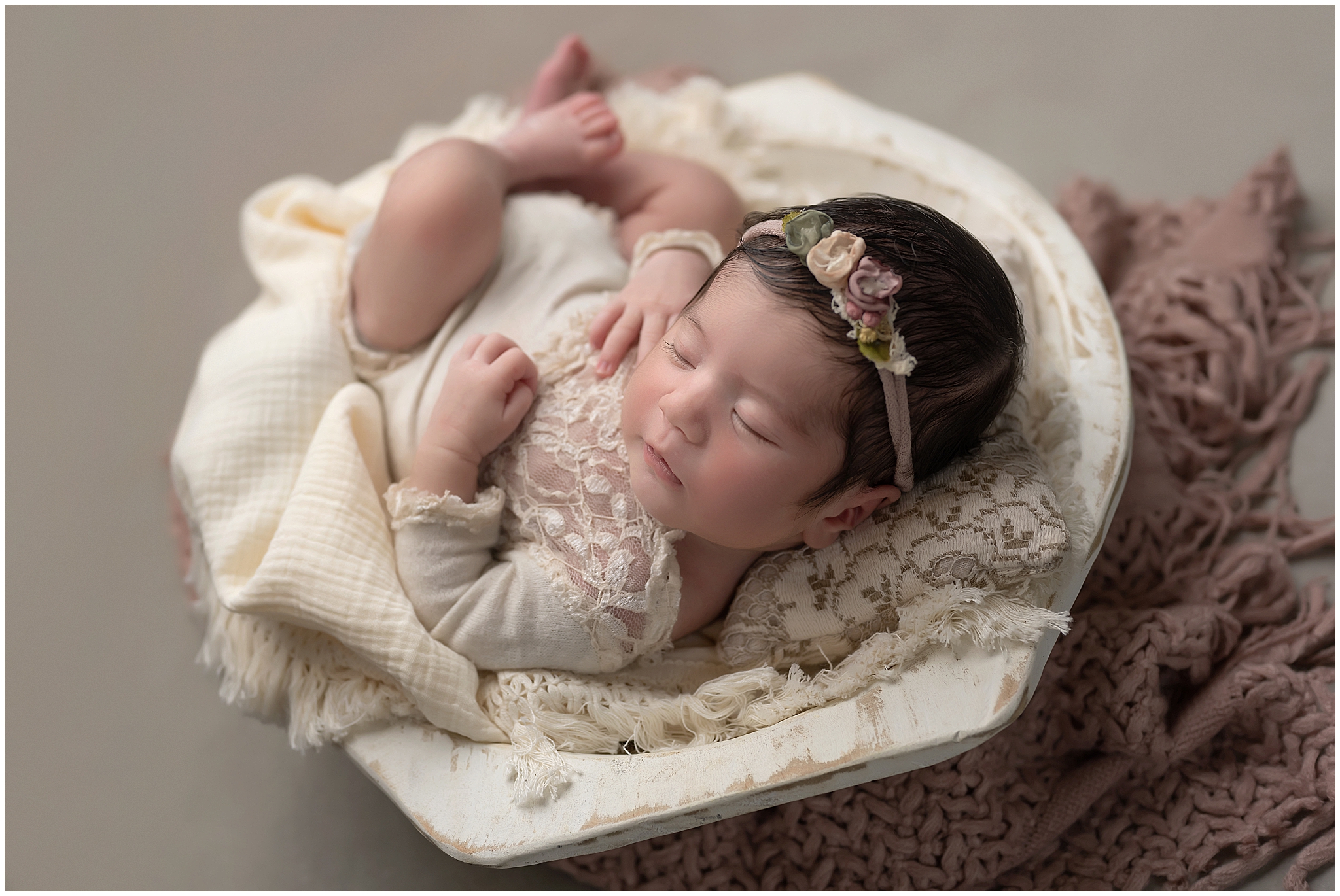 baby girl sleeping in bowl during newborn photo session at studio in london ontario