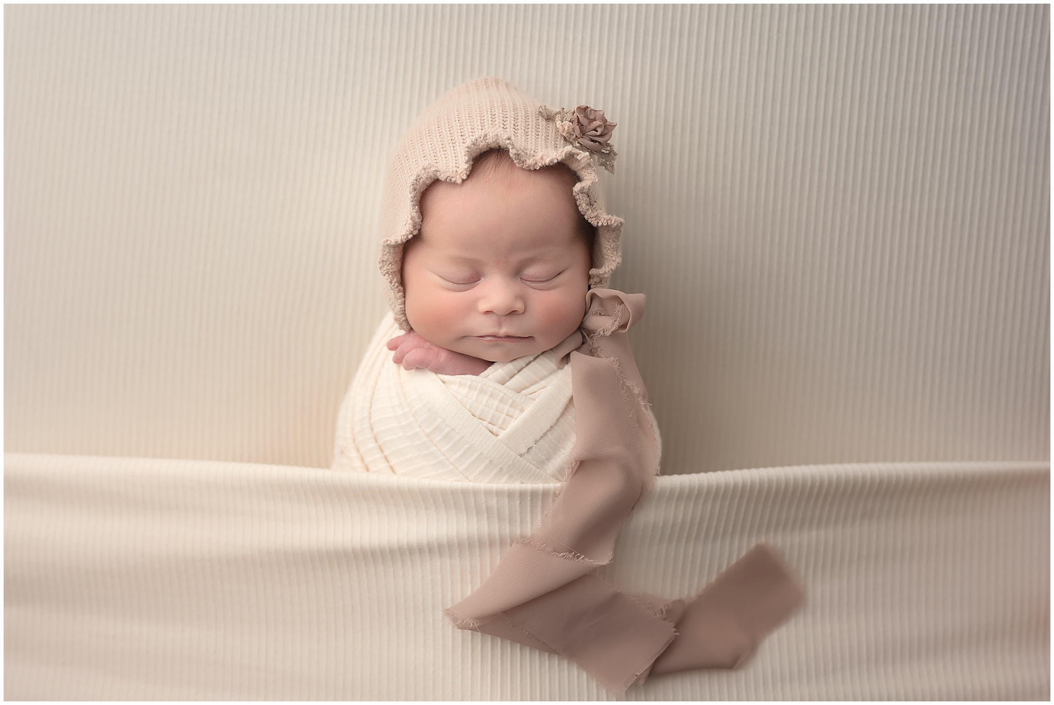 baby girl sleeping during newborn session at photography studio in london ontario