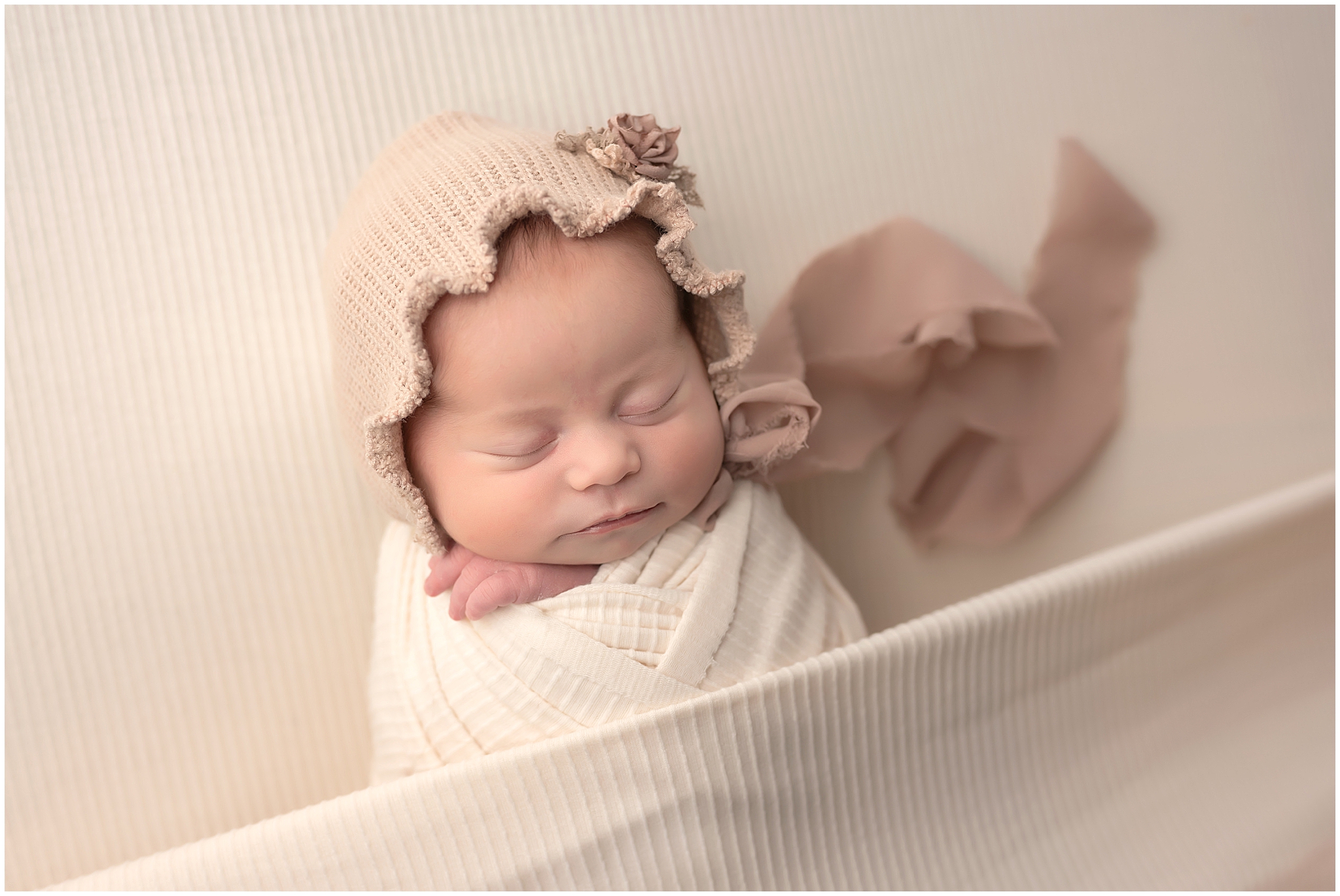baby girl sleeping during newborn session at photography studio in london ontario