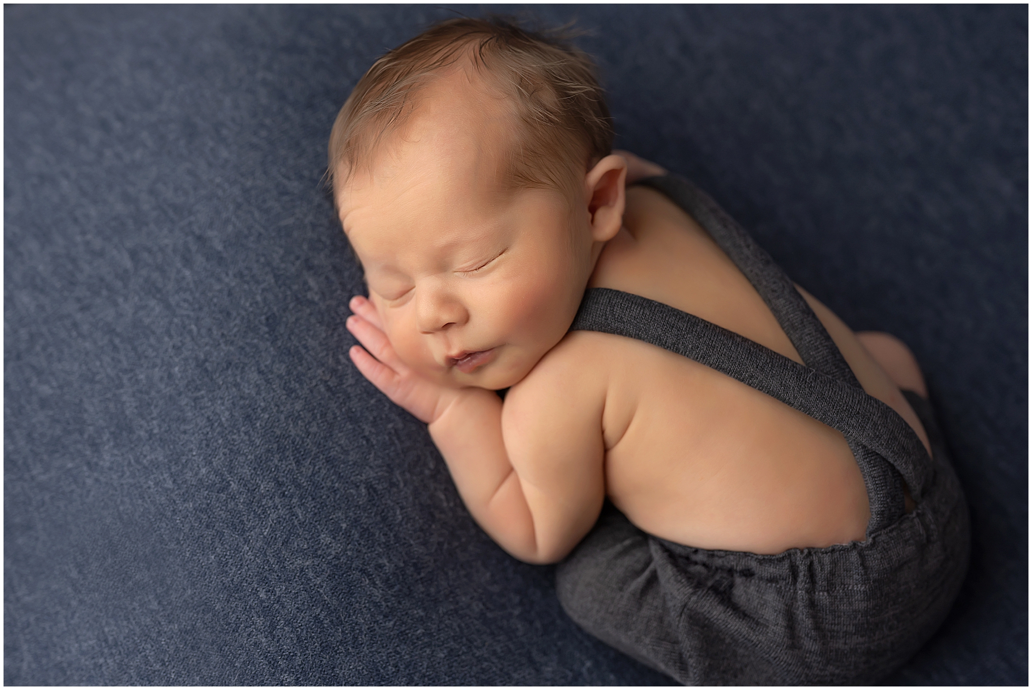 newborn baby posing on pillow during photography session in london ontario