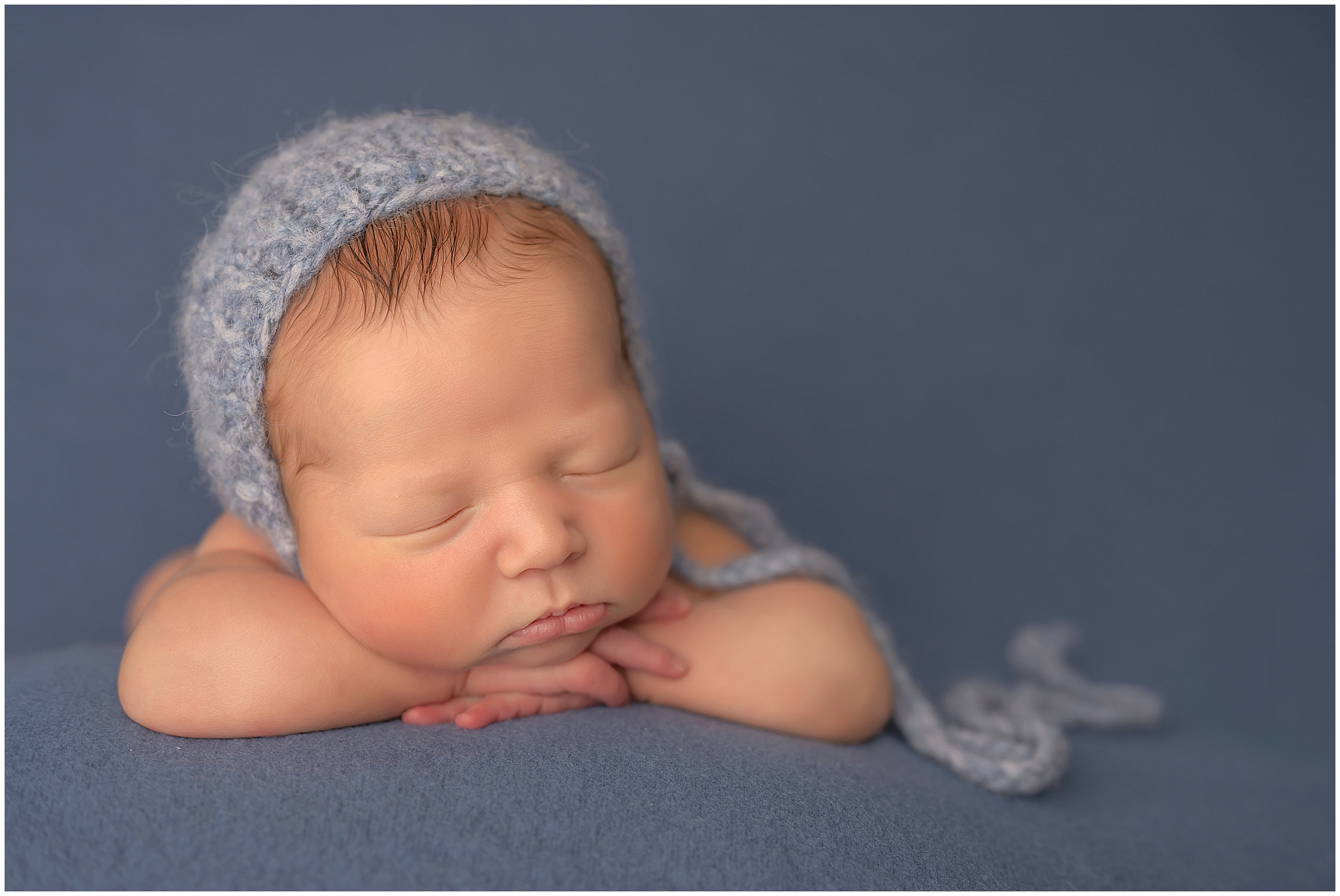 baby boy posing during newborn photography session in london ontario