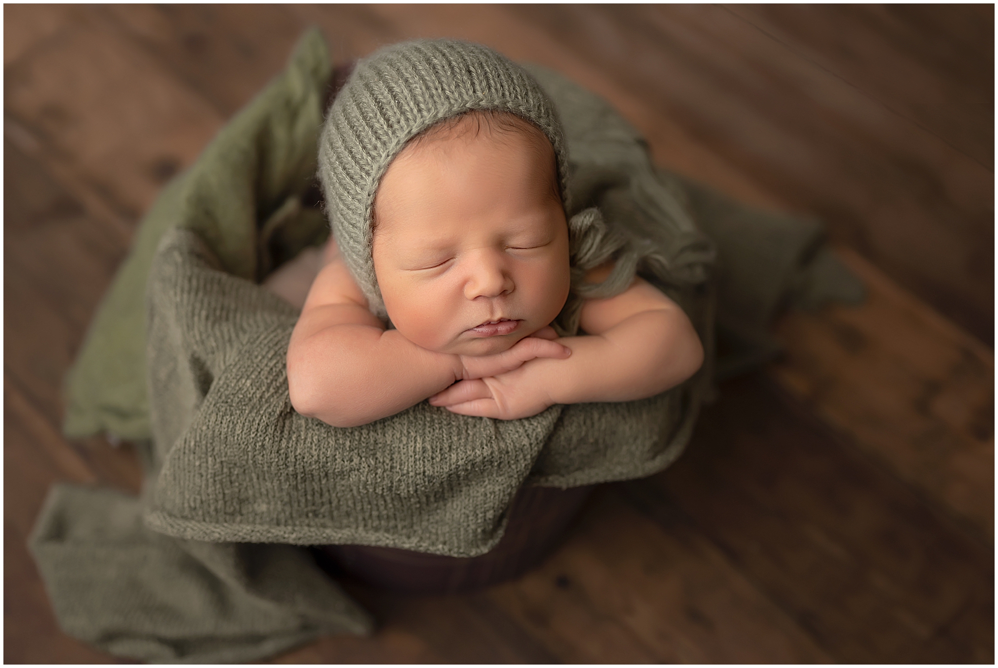 Baby in bucket during newborn session at studio in london ontario