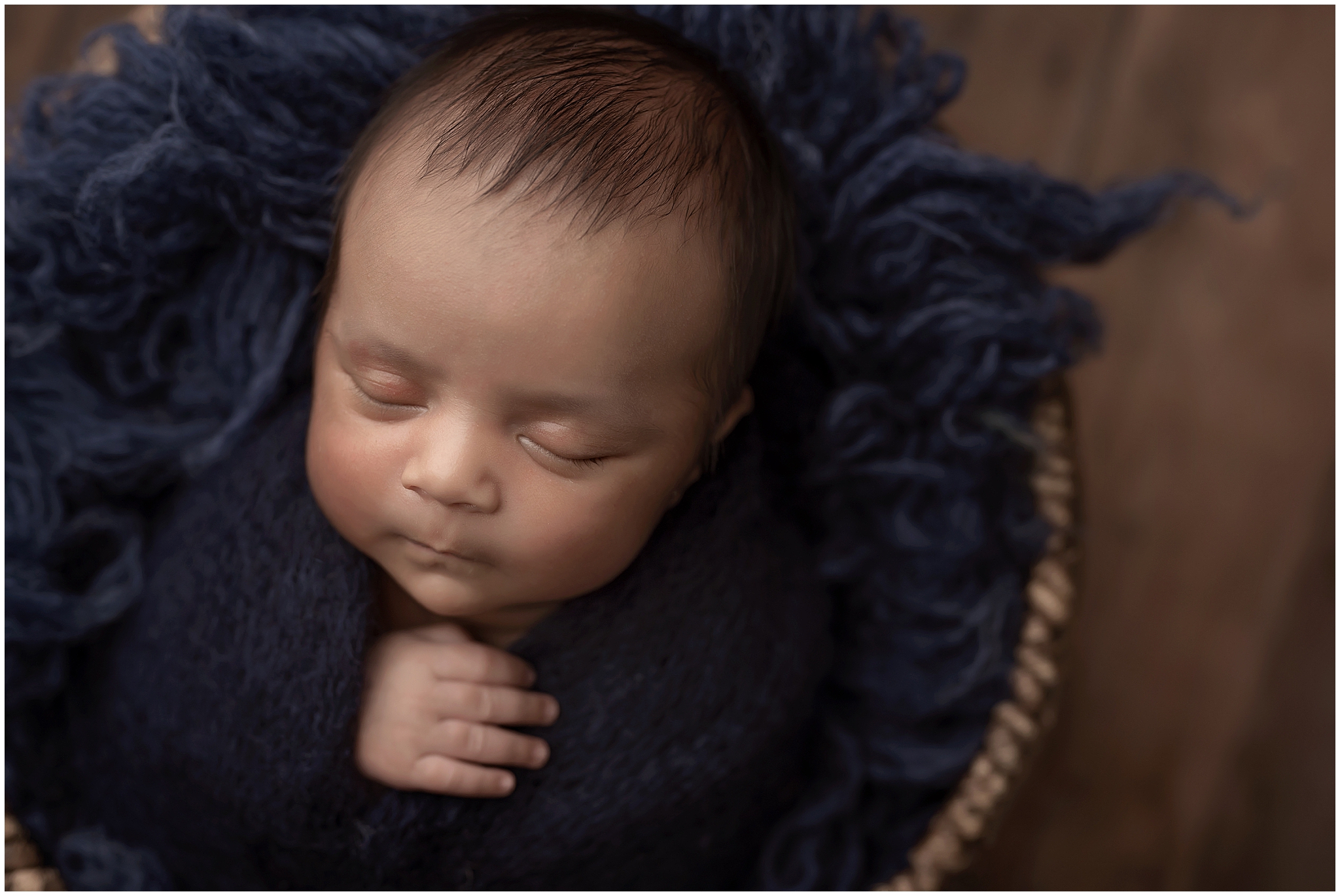baby wapped and sleeping  during newborn photography session at london ontario studio
