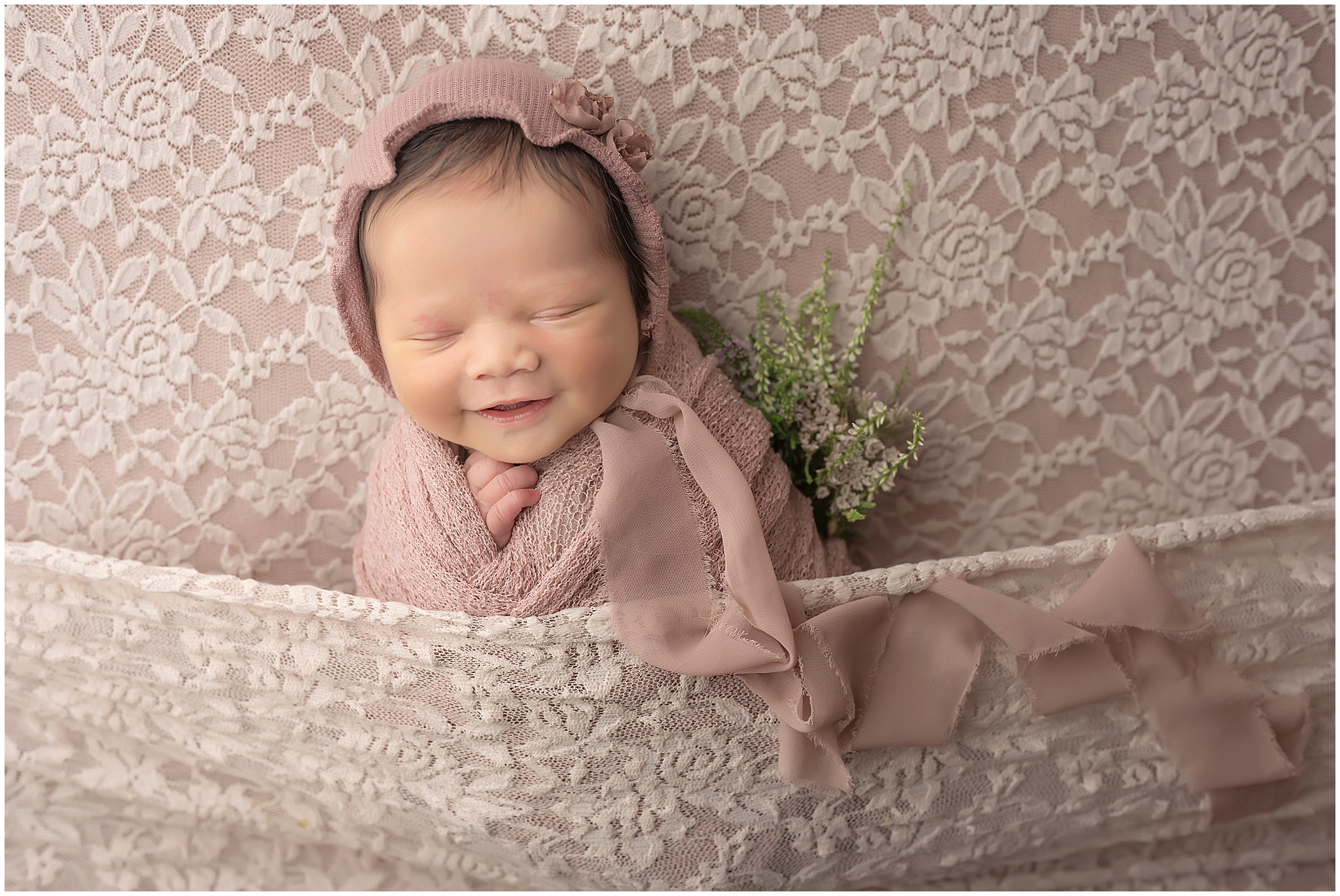 newborn baby smiling during photography session at london ontario studio