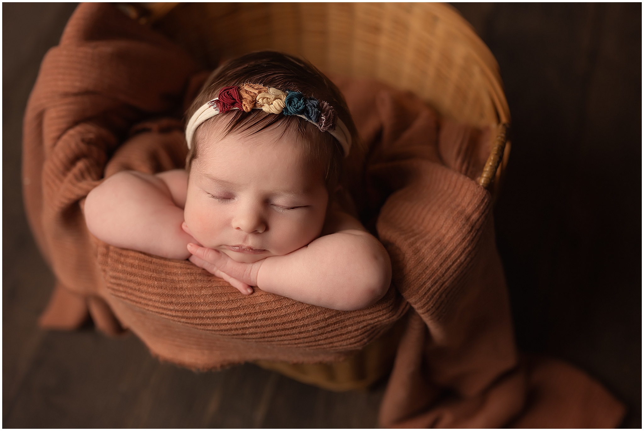 newborn baby girl sleeping in bucket duriong photography session in london ontario