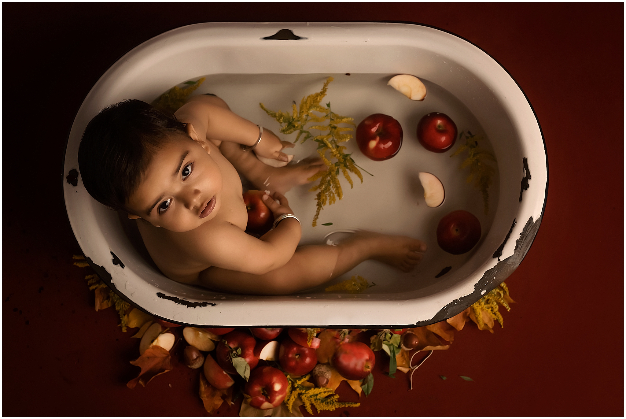 baby in fruit bath during first birthay photo session in london ontario