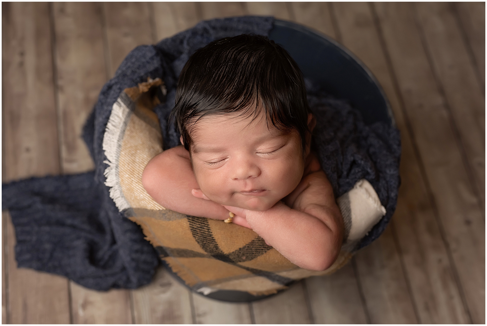 baby posing in bucket during newborn session in london ontario