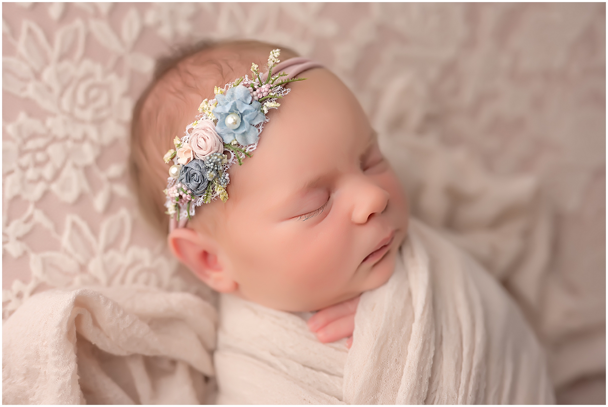 wrapped newborn baby sleeping during newborn photography session in london ontario