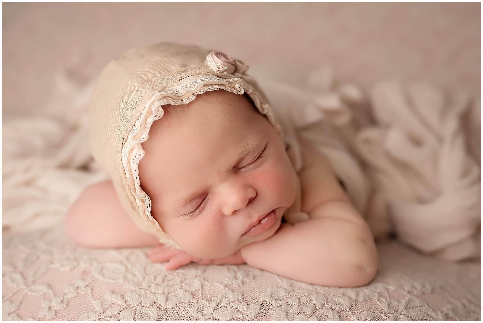 head on hands pose baby sleeping on pastel pink for newborn photographer in london ontario