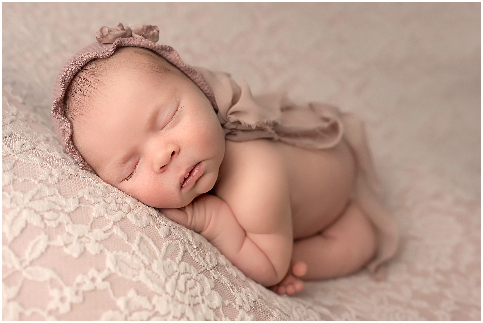 taco pose baby sleeping on pastel pink for newborn photographer in london ontario