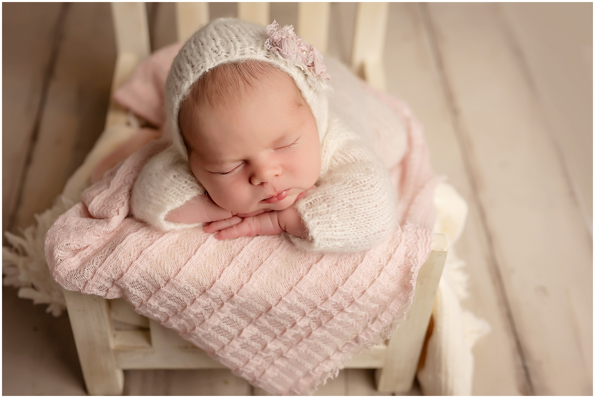 newborn baby sleeping on tiny bed at photography studio in london ontario