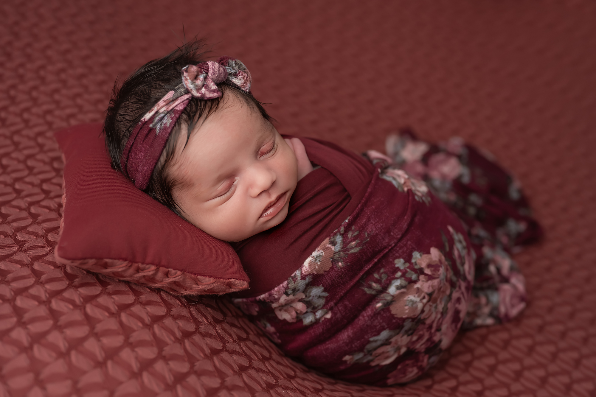 newborn baby wrapped and sleeping during baby photography session in London Ontario