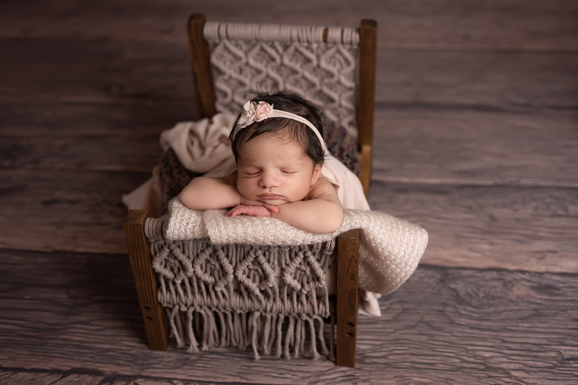 newborn baby girl sleeping i tiny bed during photography session in london ontario