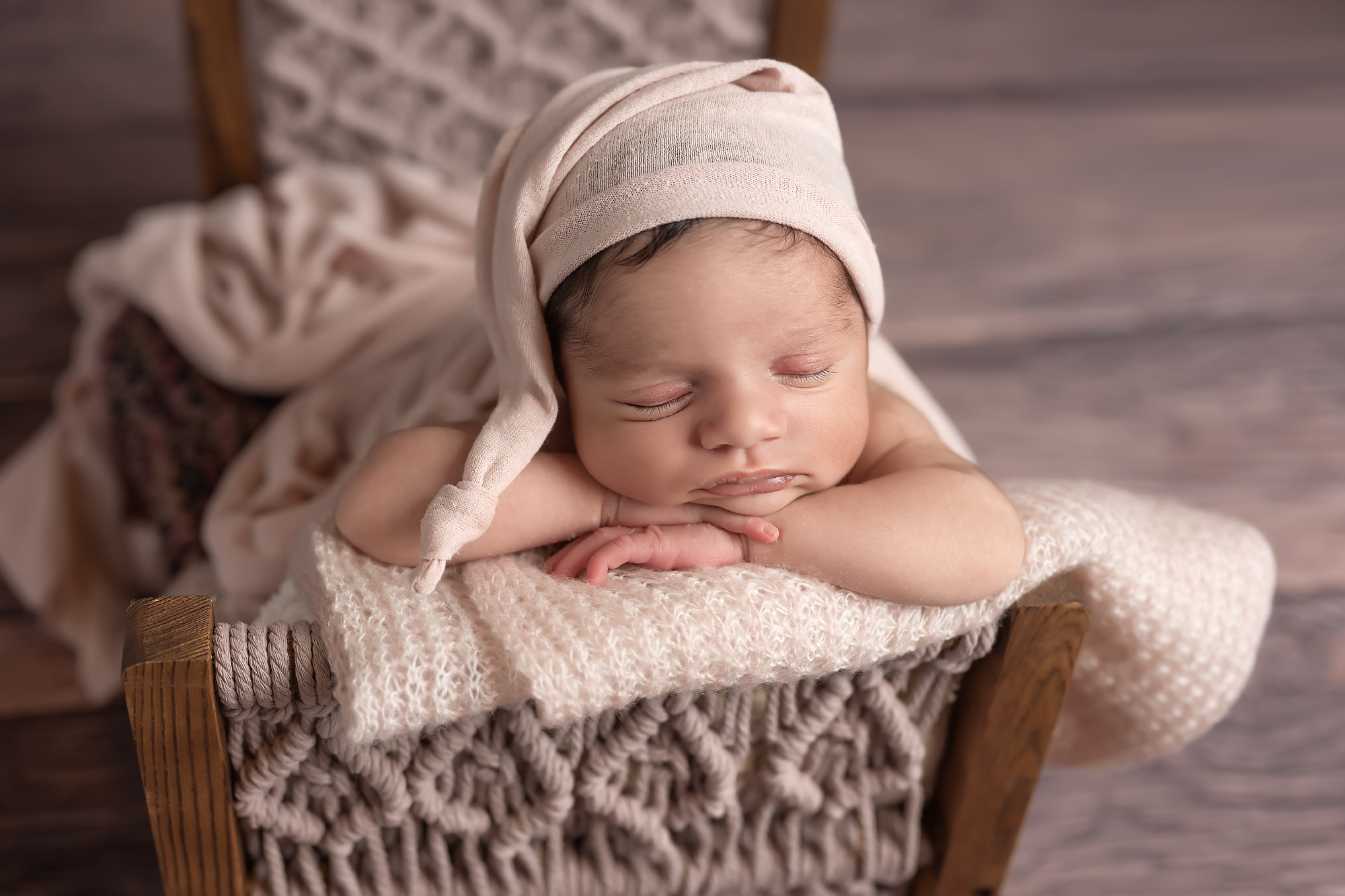 baby girl sleeping in tiny bed during newborn session in london ontario