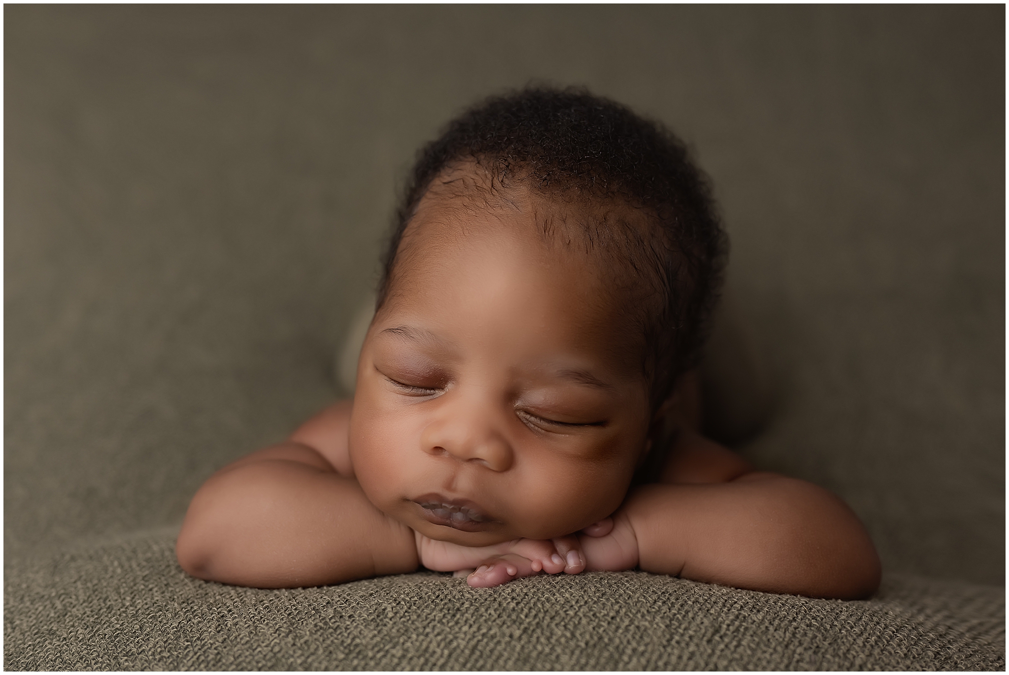 head on hands pose of baby taken during newborn photography session in london ontario